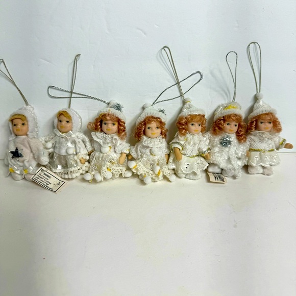 GANZ Other - NWT. 7 porcelain doll ornaments. 5 of little girl and 2 of baby.
